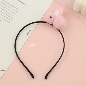 Detailed view of plush pink bunny ear headband with soft 3D rabbit on pastel background