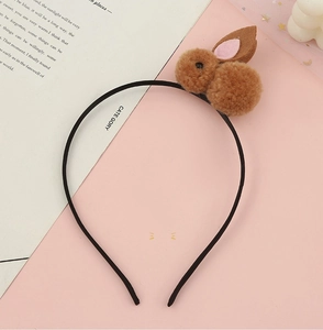 Detail of a black headband with a cute brown plush bunny featuring pink inner ears