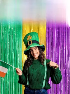 Detail of green, purple, and gold tinsel foil fringe curtains for festive party background