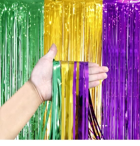 Close-up of flexible green, gold, and purple tinsel curtain for party background decor