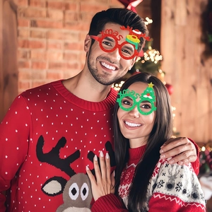 Close-up of festive Christmas glitter glasses worn by models in a holiday party setting