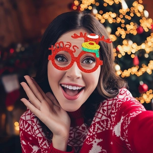 Close-up of red glitter Christmas glasses with Xmas lettering and a reindeer icon