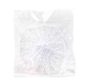 Detailed view of a transparent star-shaped Christmas ornament inside a clear poly bag