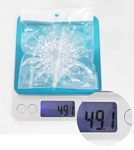 Macro shot of 49g clear acrylic snowflake ornaments on digital scale for Christmas DIY