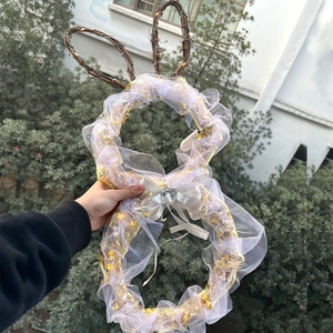 Lighted Easter bunny wreath with white lace and silver bow on natural grapevine base