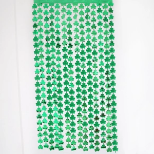 Metallic green shamrock foil fringe curtain for St. Patrick's Day party backdrop decoration