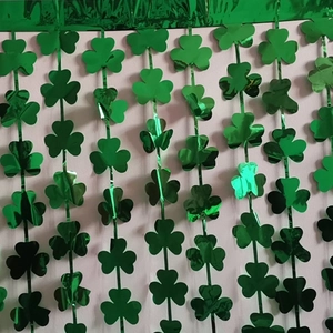 Close-up of green metallic shamrock foil fringe curtain for St. Patrick's Day party decor