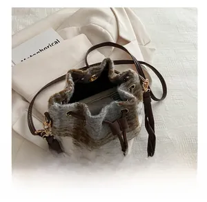 Interior view of plush bucket bag showing storage capacity and woven strap detail