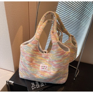 Detail of colorful fluffy knit tote bag featuring soft texture and woven brand label