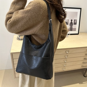Retro black oversized tote bag with dual pockets and adjustable silver metal buckle strap