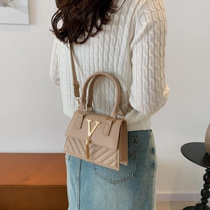Vintage beige crossbody bag with gold V logo and tassel detail in quilted PU leather