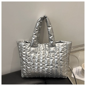 Close-up of silver quilted texture and metallic finish on a stylish tote bag