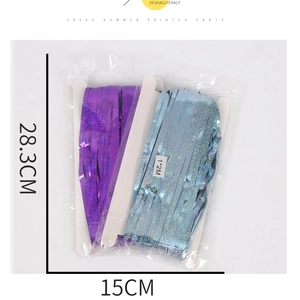 Detailed view of 1x2m laser purple and light blue fringe curtains in retail packaging