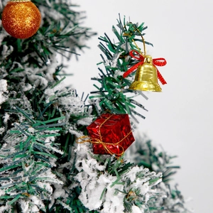 Christmas tree ornaments set featuring gold bell, red gift box and glitter ball on snowy branch