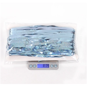 Detail shot of light blue laser tinsel curtain in packaging weighing 87.4g on a scale