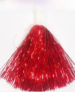 Close-up of vibrant red metallic cheerleading pom poms with a white plastic handle grip