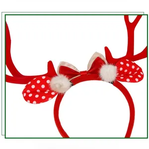 Detail of red Christmas antler headband with satin bow and white faux fur pom-poms
