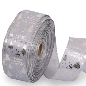 Close-up of silver Christmas ribbon roll with glittery Joy Love and Peace text