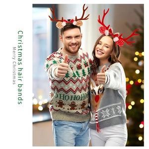 Close-up of couple wearing red and brown Christmas reindeer antler headbands with bow details