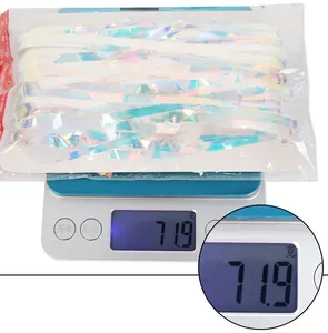 Detailed view of iridescent foil fringe curtain weight at 71.9 grams on digital scale