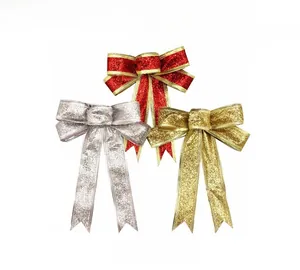 Close-up of glittery Christmas bows in red gold and silver for festive tree decoration