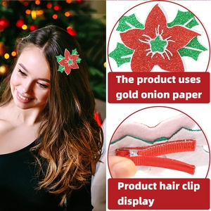 Detail view of glitter paper Christmas flower hair clip with a red ribbon wrapped metal base