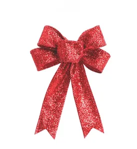 Close-up of bright red glitter bow with decorative shimmering sequins for Christmas gifts