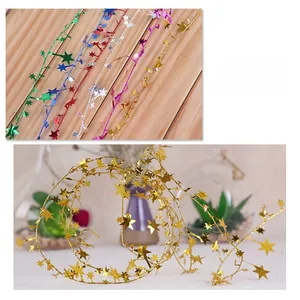 Macro detail of golden star wire garland for festive Christmas tree decoration