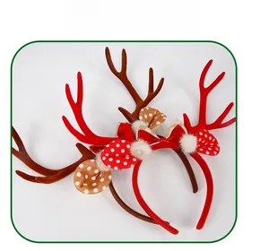 Detail of Christmas reindeer antler headbands with red bows and plush ball ornaments