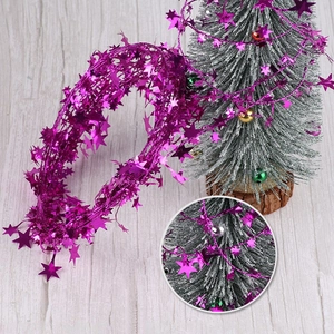 Detail of fuchsia star tinsel garland for Christmas tree and holiday party decoration