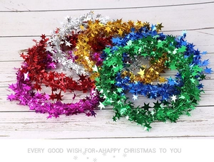 Close-up of multicolored 7.5m star tinsel garlands for Christmas tree decoration