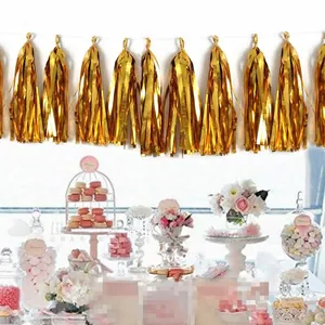 Detail of metallic gold foil fringe garland for birthday party backdrop decoration