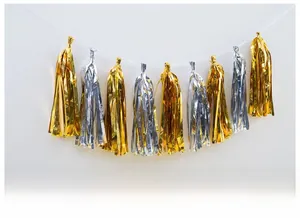 Detail of hanging gold and silver foil fringe tassels for party background wall decor
