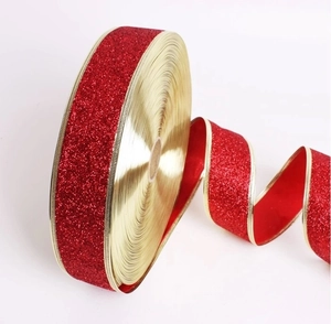Detail of red glitter ribbon with gold wire edges for Christmas tree gift wrapping decor