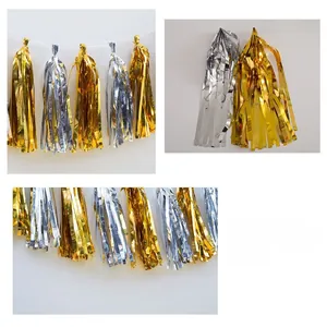 Detail of metallic gold and silver foil tassel garlands for birthday party wall decoration