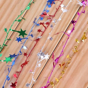 Close-up of colorful star-shaped tinsel garlands for Christmas tree and party decoration