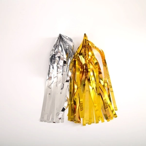 Close-up of metallic gold and silver foil fringe tassels for festive party backdrop décor