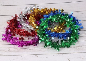 Close-up of colorful star tinsel garlands in six metallic shades for Christmas decoration