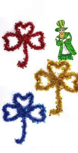 Detail view of colorful Saint Patrick's Day DIY shamrock ornaments in red, gold, and blue