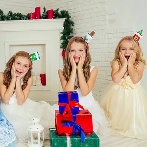 Close-up of three festive Christmas mini hat headbands with glitter and festive details