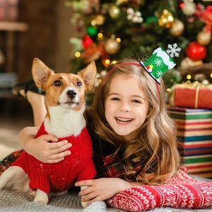 Girl wearing a festive green sequin Christmas hat headband with holiday decorations