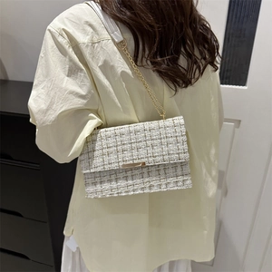 Fashionable beige tweed crossbody chain bag for women with gold metal buckle detail