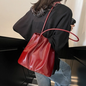 Minimalist red glossy patent leather tote bag with slender shoulder straps for women