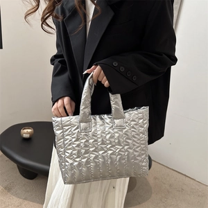 Silver quilted tote bag with metallic finish and wavy texture for modern urban fashion
