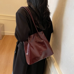 Large vintage burgundy patent leather tote bag for women showing spacious shoulder carry style