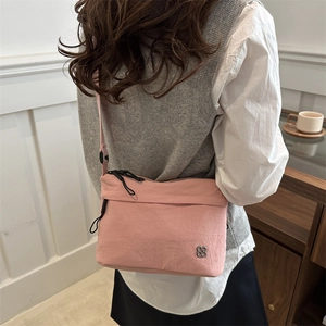 Pink lightweight nylon shoulder bag with texture and clover logo for casual daily use
