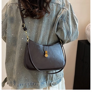 Detail shot of the dark brown leather hobo bag with vintage gold buckle on shoulder