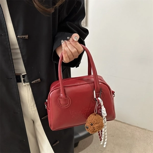Red leather Boston handbag with letter embossing and a cute brown teddy bear pendant