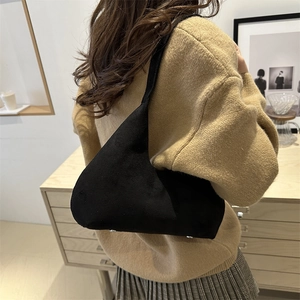 Minimalist black oversized shoulder bag in matte suede finish for casual commute