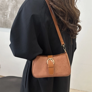 Vintage brown suede underarm bag with gold circular buckle and leather strap